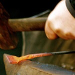 Canva – Blacksmith Heating Iron