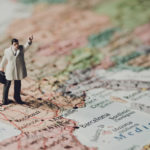 Miniature businessman on map of Europe